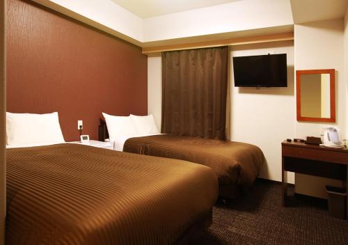 En eller flere senge i et værelse på Hotel Trend Kanazawa Katamachi
