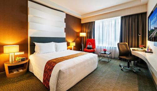 a hotel room with a bed and a desk at Hotel Armada Petaling Jaya in Petaling Jaya