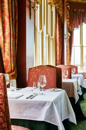 a dining room with two tables with wine glasses at Chateau Yering in Yarra Glen