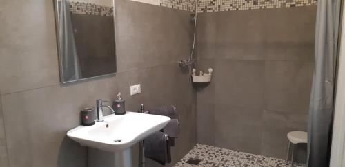 a bathroom with a sink and a shower at Guest House Green Heart in Omegna