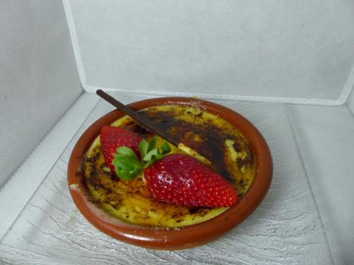 a bowl of food with two strawberries in it at Hotel Vall d´Aneu in Esterri d'Àneu