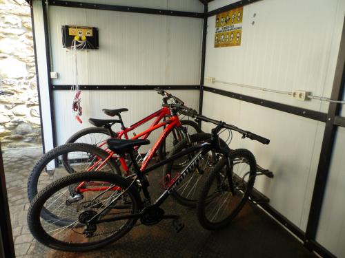 two bikes parked next to each other in a garage at Hotel Vall d´Aneu in Esterri d'Àneu