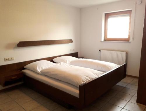 1 dormitorio con 2 camas y ventana en Brachfeld zehneins Ferienwohnung, en Sulz am Neckar