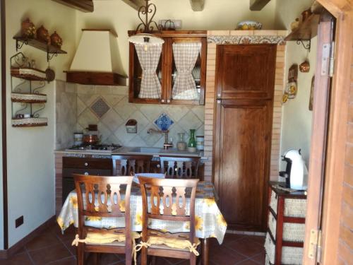 a kitchen with a table and chairs in a room at Casa Vacanze 'Al Giardino degli Ulivi' in Marinella di Selinunte