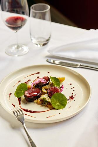a plate of food on a table with a fork at Chateau Yering in Yarra Glen