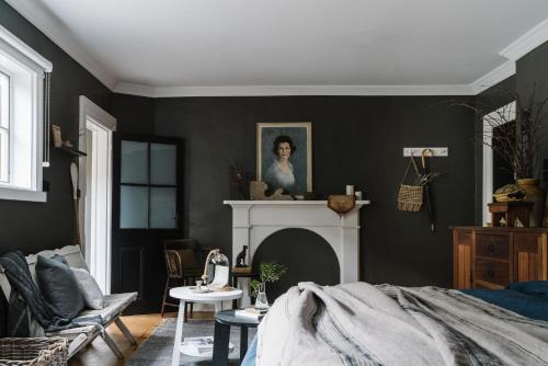 a living room with a bed and a fireplace at Ship Inn Stanley in Stanley