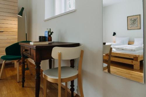 a room with a desk and a mirror and a bed at Villa Breitenberg in Breitenberg