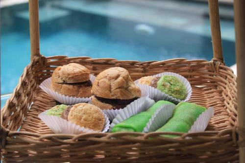 a basket filled with muffins and differentiatesiatesiatesiatesktop at DISINI Luxury Spa Villas-CHSE Certified in Seminyak