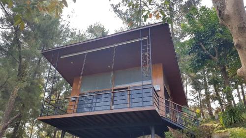 a house with a large balcony on top of a tree at Manohara Resort in Borobudur