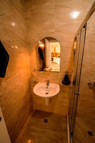 a bathroom with a sink and a shower at Zornitsa Apart in Primorsko