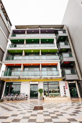 a tall building with bikes parked in front of it at Lisinty Resort in Hengchun