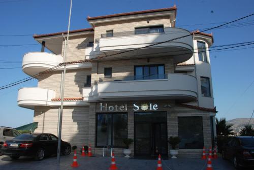 a hotel style building with orange cones in front of it at Hotel Sole in Sarandë