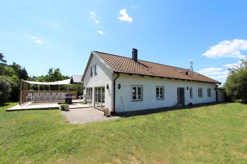 a small white house with a large yard at Villa M in Simrishamn