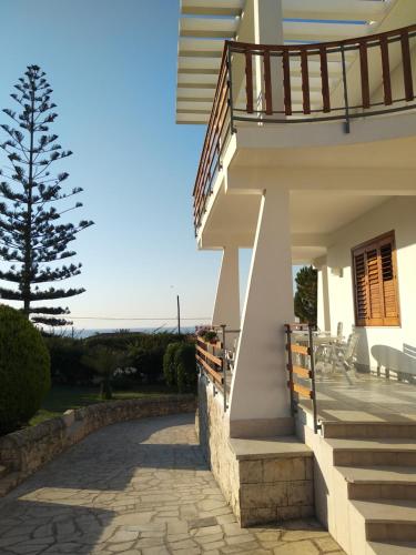 a house with a staircase leading to a patio at VILLA VEGA in Fontane Bianche