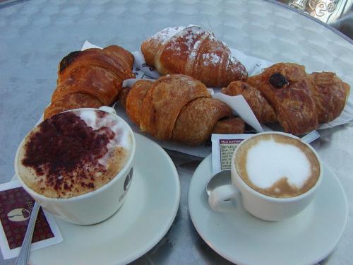a table with a plate of pastries and a cup of coffee at Le Terrazze in Olevano sul Tusciano
