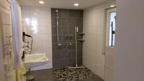 a bathroom with a shower and a sink at Landgasthaus zur Linde in Fürstenhagen