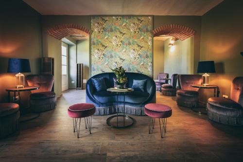 a living room with a couch and chairs and a table at Residenza San Vito in Calamandrana