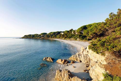 a view of a beach with rocks and water at Residence Cala Viola in Cala Liberotto