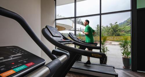 a man standing on a treadmill in a gym at Pao's Sapa Leisure Hotel in Sa Pa