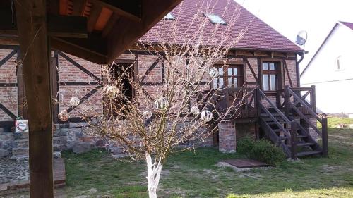 a building with a tree in front of it at AgroKorytnica in Stara Korytnica