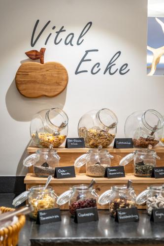 a display of different types of food in glass jars at Richstein's Posthotel in Bad Füssing