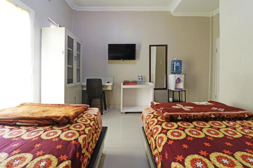 Ліжко або ліжка в номері Hotel Graha Soeltan