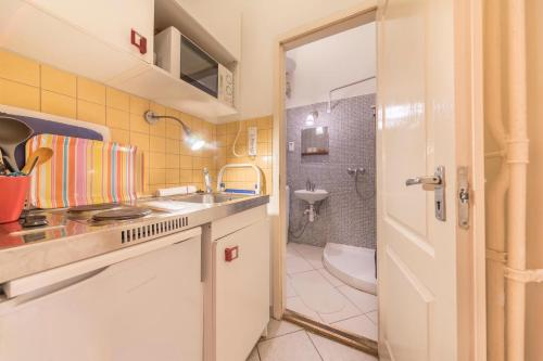 a small bathroom with a sink and a toilet at Miso Apartment in Budapest