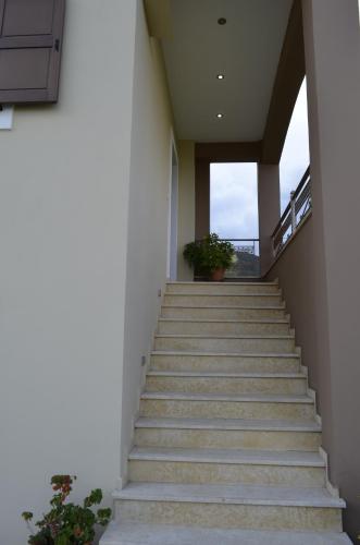 a set of stairs in a building with a potted plant at Agnanti Villas in Nafpaktos