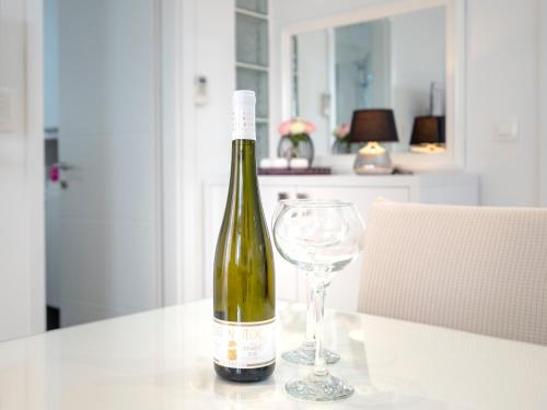 a bottle of wine and a wine glass on a table at Apartments Roso - ZF Hvar in Hvar