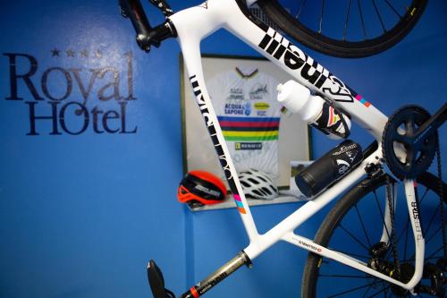 a white bike parked next to a wall at Hotel Royal in Fermo