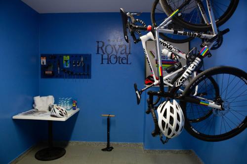 a bike hanging from a wall with a helmet on it at Hotel Royal in Fermo