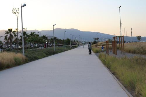 a person walking down a path in a field at Marchica Apartment Nador Jadid Wifi Klima in Nador