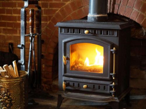 a wood burning stove in a brick oven at Holiday Home Ty Llan by Interhome in Llanwrtyd