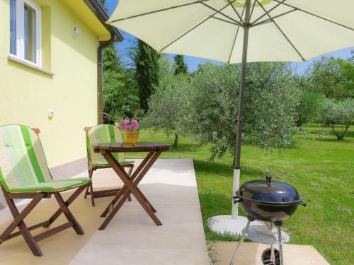 un patio con griglia e tavolo con barbecue di Holiday Home Lucija by Interhome a Vinež