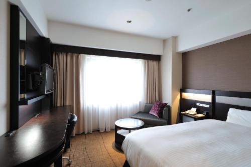 Ein Bett oder Betten in einem Zimmer der Unterkunft Hotel Granvia Hiroshima