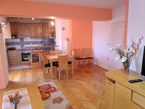 a kitchen and dining room with a table and chairs at S.K Apartments in Ohrid