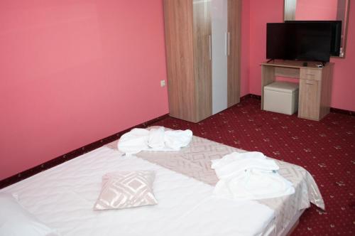 a hotel room with a bed with towels on it at Hotel Jaky SPA Complex in Kranevo