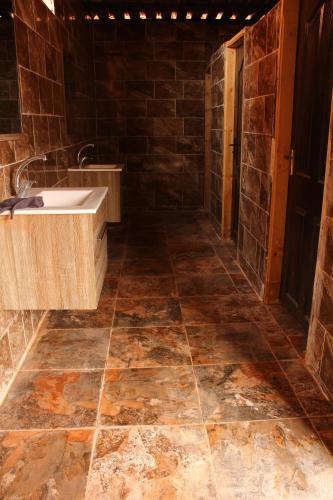 a bathroom with a sink and a tile floor at Wadirum sunrise camp in Wadi Rum
