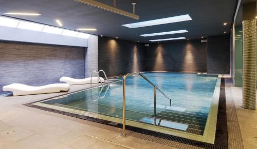 a large swimming pool in a building with at Apex Waterloo Place Hotel in Edinburgh