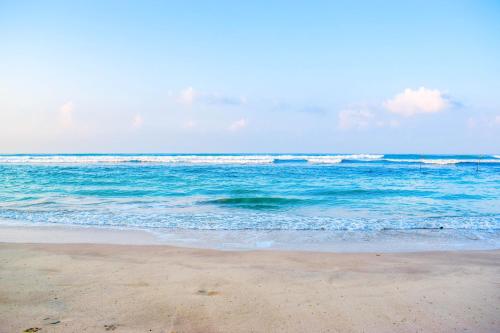 a sandy beach with the ocean in the background at Insight Resort Ahangama - S&S Other Certified in Ahangama