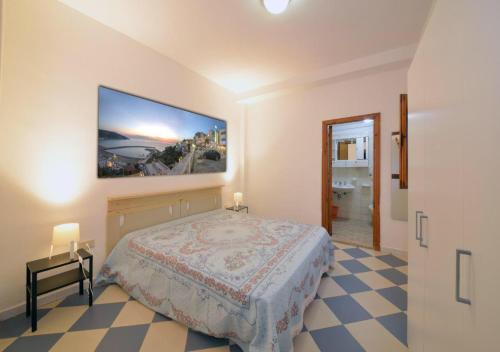 a bedroom with a bed and a painting on the wall at Residence Dattoli in Peschici