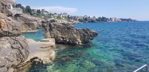a view of the ocean from a rocky shore at Apartman Haris in Dobra Voda
