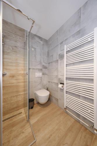a bathroom with a toilet and a shower stall at Apartments Ivanov in Zadar