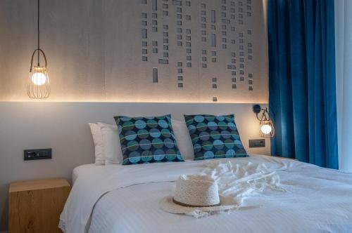 a bedroom with a bed with a hat on it at ELIXIA in Tolo