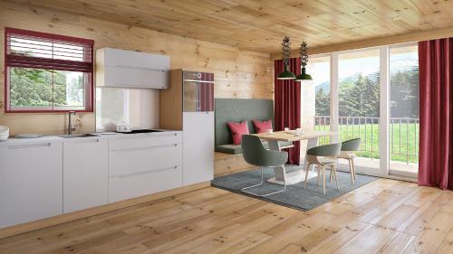 a kitchen and dining room with a table and chairs at HOCHoben Chalets & Mobilhomes in Mallnitz
