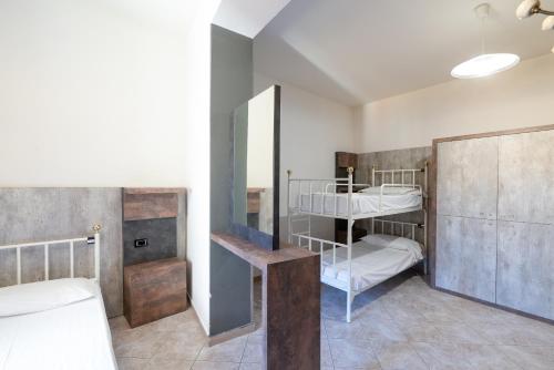 a bedroom with a bed and a dresser at Hostel Archi Rossi in Florence