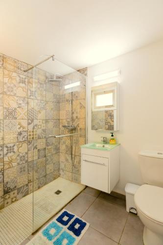 a bathroom with a shower and a toilet and a sink at Savvas City Centre Flat in Larnaka