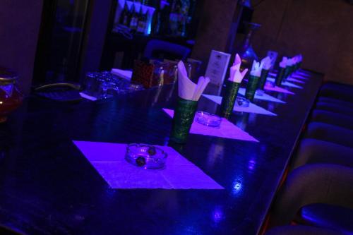 a long table with purple lights on it at New Farah Hotel in Agadir