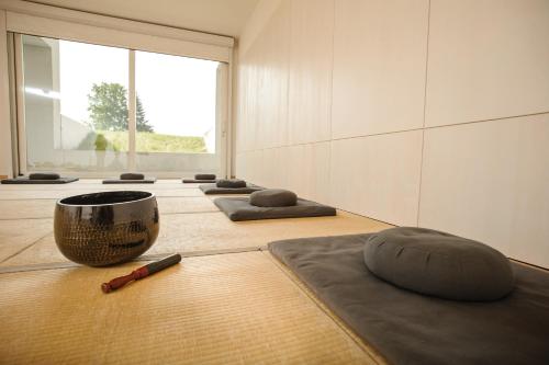 a room with a row of meditation mats on the floor at Hotel St. Virgil Salzburg in Salzburg