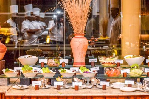 a display case with bowls of food and a vase at Insight Resort Ahangama - S&S Other Certified in Ahangama